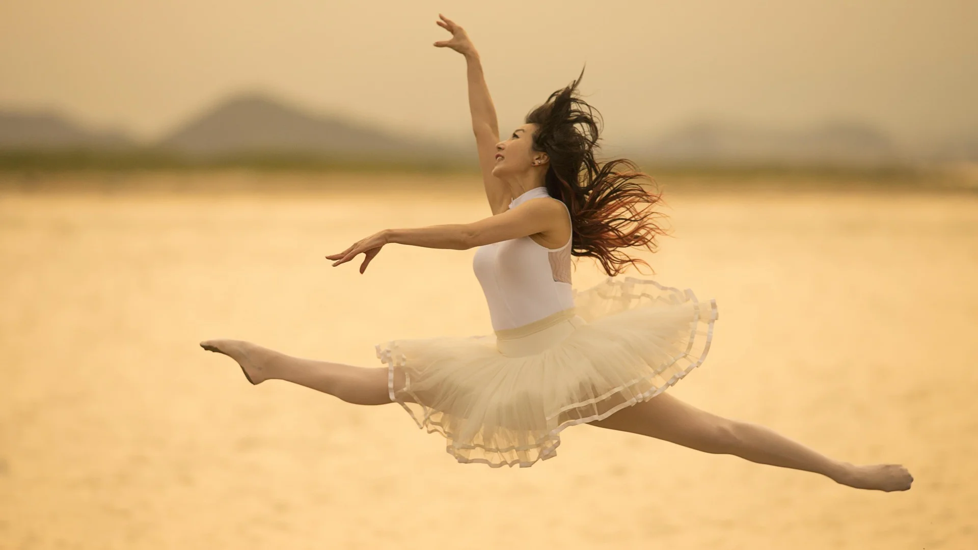An ensemble of dancers in crisp, musically phrased formation, illustrative of Pictures at an Exhibition