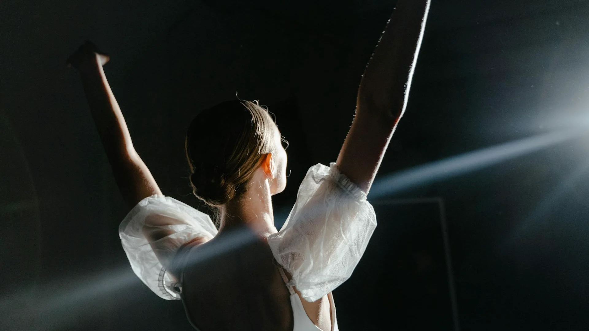 Dancers in loose, grounded postures on a bare stage, illustrative of Pavement