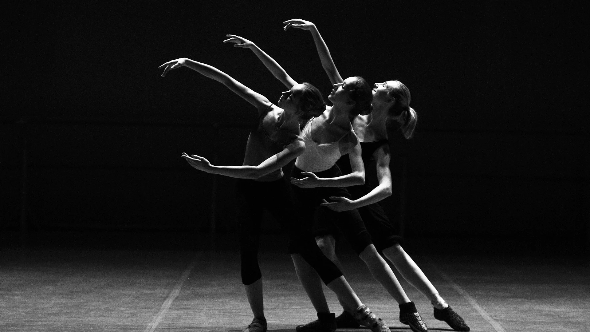 Dancers in dramatic dark lighting, illustrative of Betroffenheit