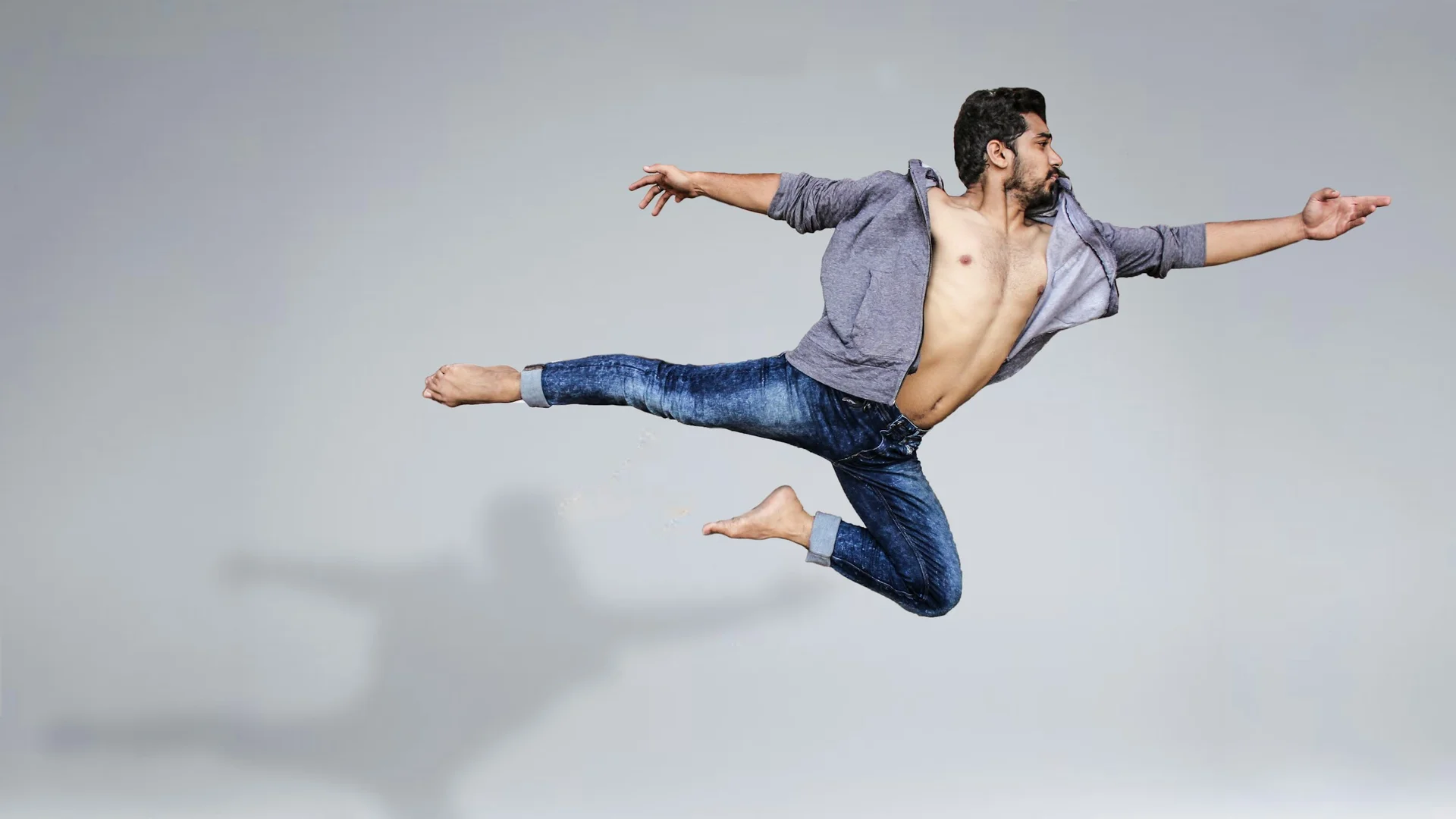 A dancer in an extreme flying leap, illustrative of In the Middle, Somewhat Elevated